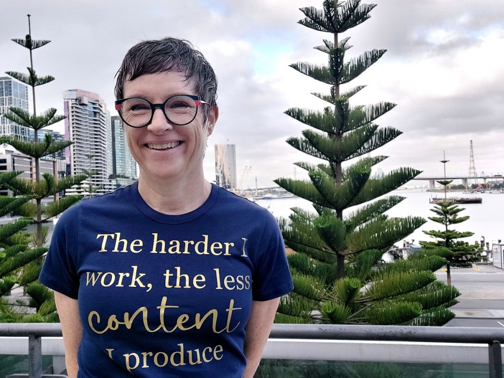 The author wearing a t-shirt that says 'The harder I work, the less content I produce'